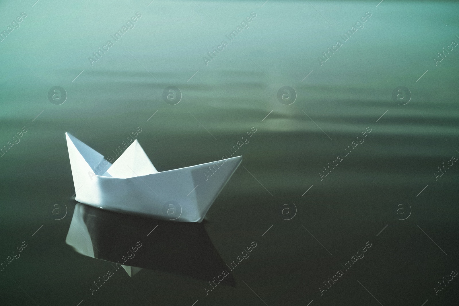 Image of White paper boat floating on river. Retro photo effect