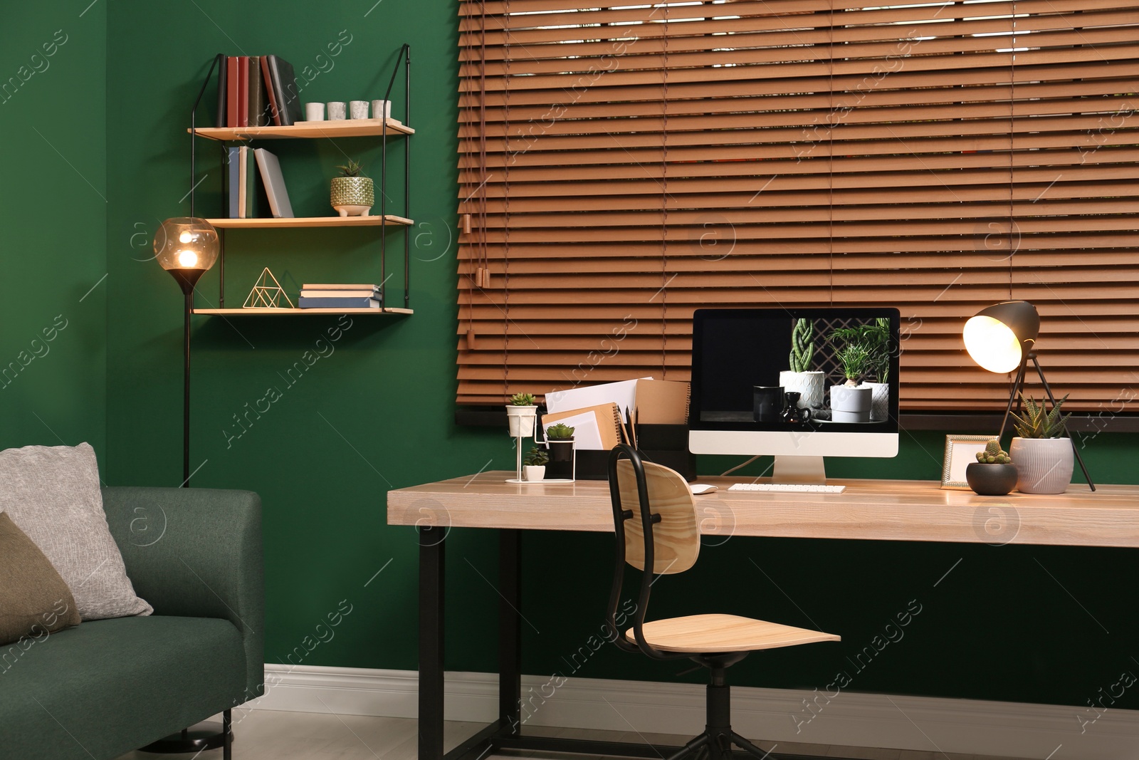 Photo of Comfortable workplace with modern computer near window in room. Interior design