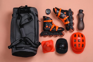 Photo of Sports bag and roller skating equipment on color background, flat lay
