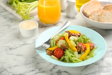 Photo of Delicious fresh celery salad on white marble table