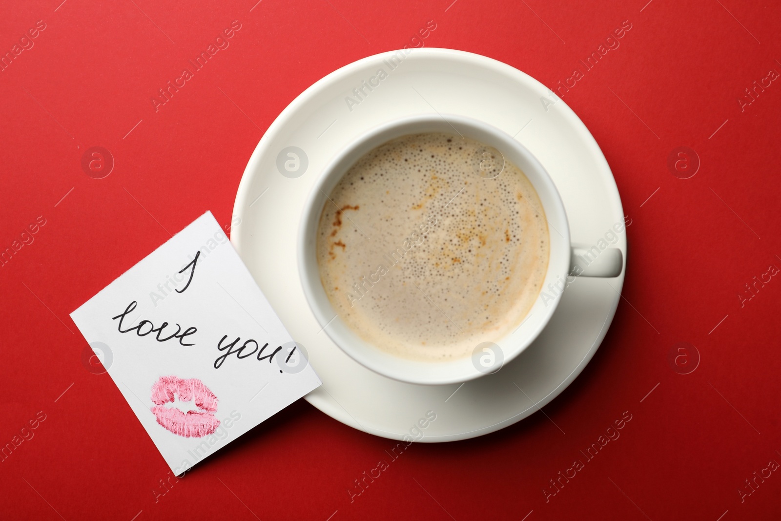 Photo of Paper with words I Love You and coffee on red background, flat lay