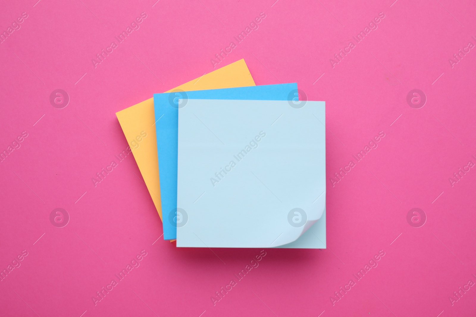 Photo of Colorful empty notes on pink background, top view