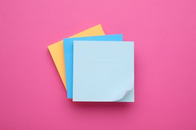Photo of Colorful empty notes on pink background, top view