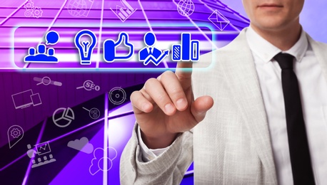 Business plan. Man pointing at virtual screen with different icons, closeup 