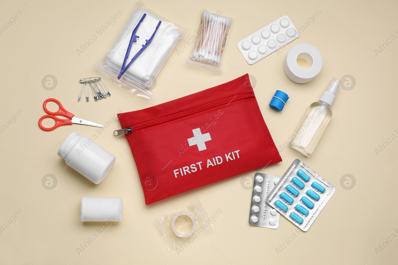 Photo of Flat lay composition with first aid kit on beige background