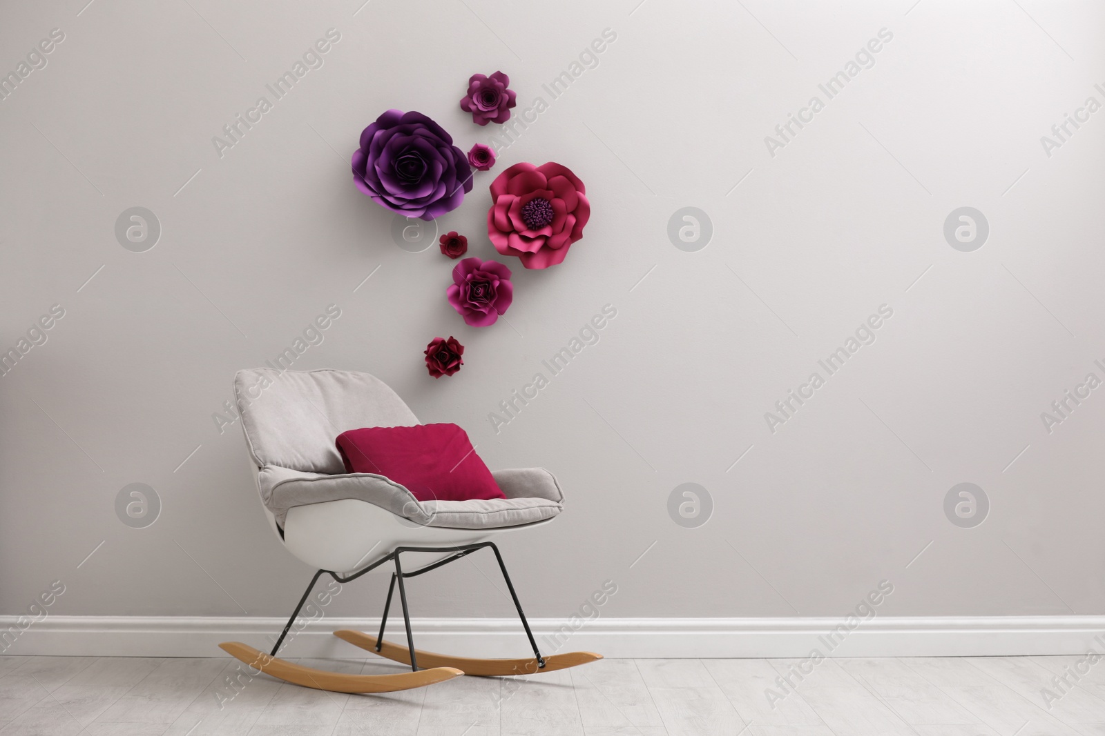 Photo of Stylish room interior with floral decor and rocking chair, space for text