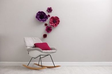 Photo of Stylish room interior with floral decor and rocking chair, space for text