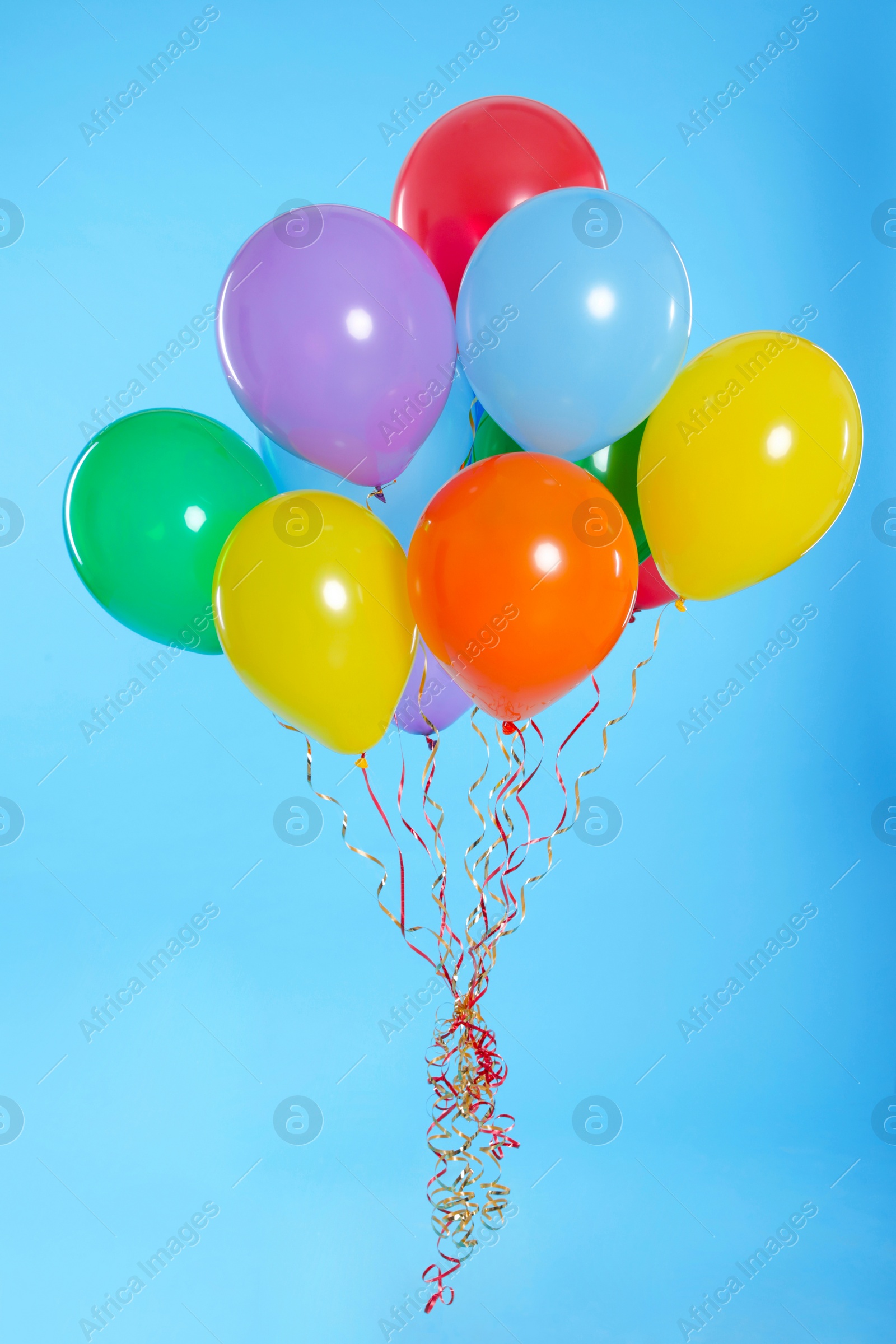 Photo of Bunch of bright balloons on color background