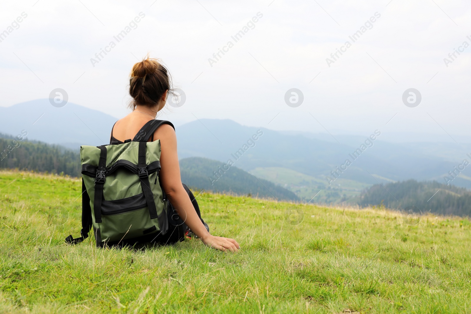 Photo of Woman with backpack in wilderness on cloudy day