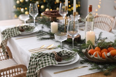 Christmas table setting with festive decor and dishware indoors