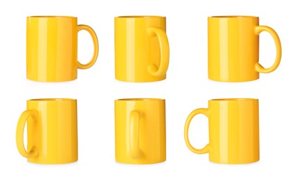 Image of Set with yellow ceramic mugs on white background