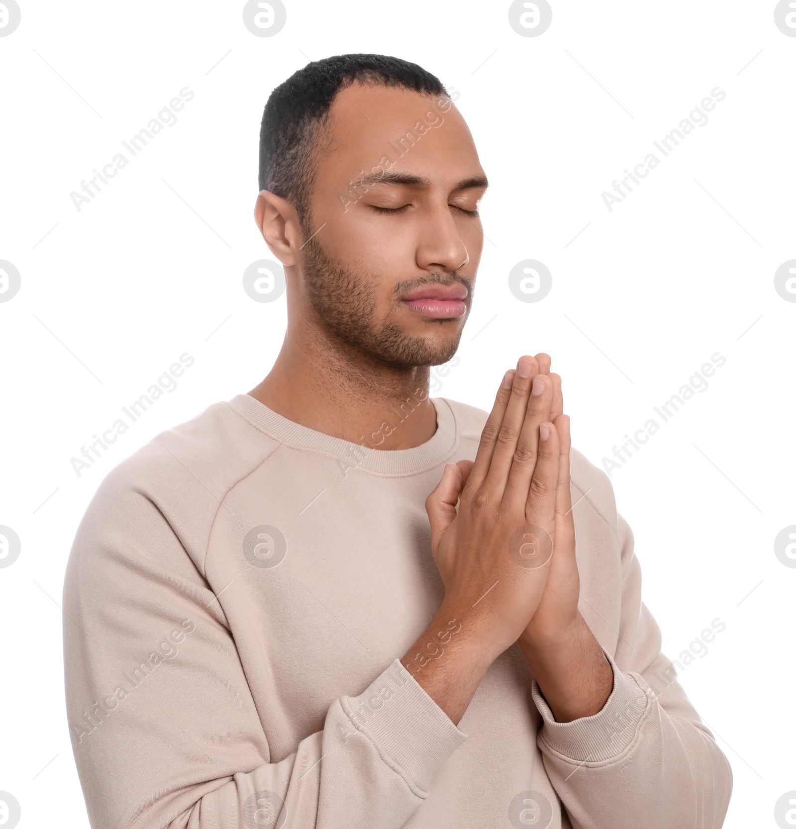 Photo of African American man with clasped hands praying to God on white background