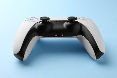Wireless game controller on light blue background