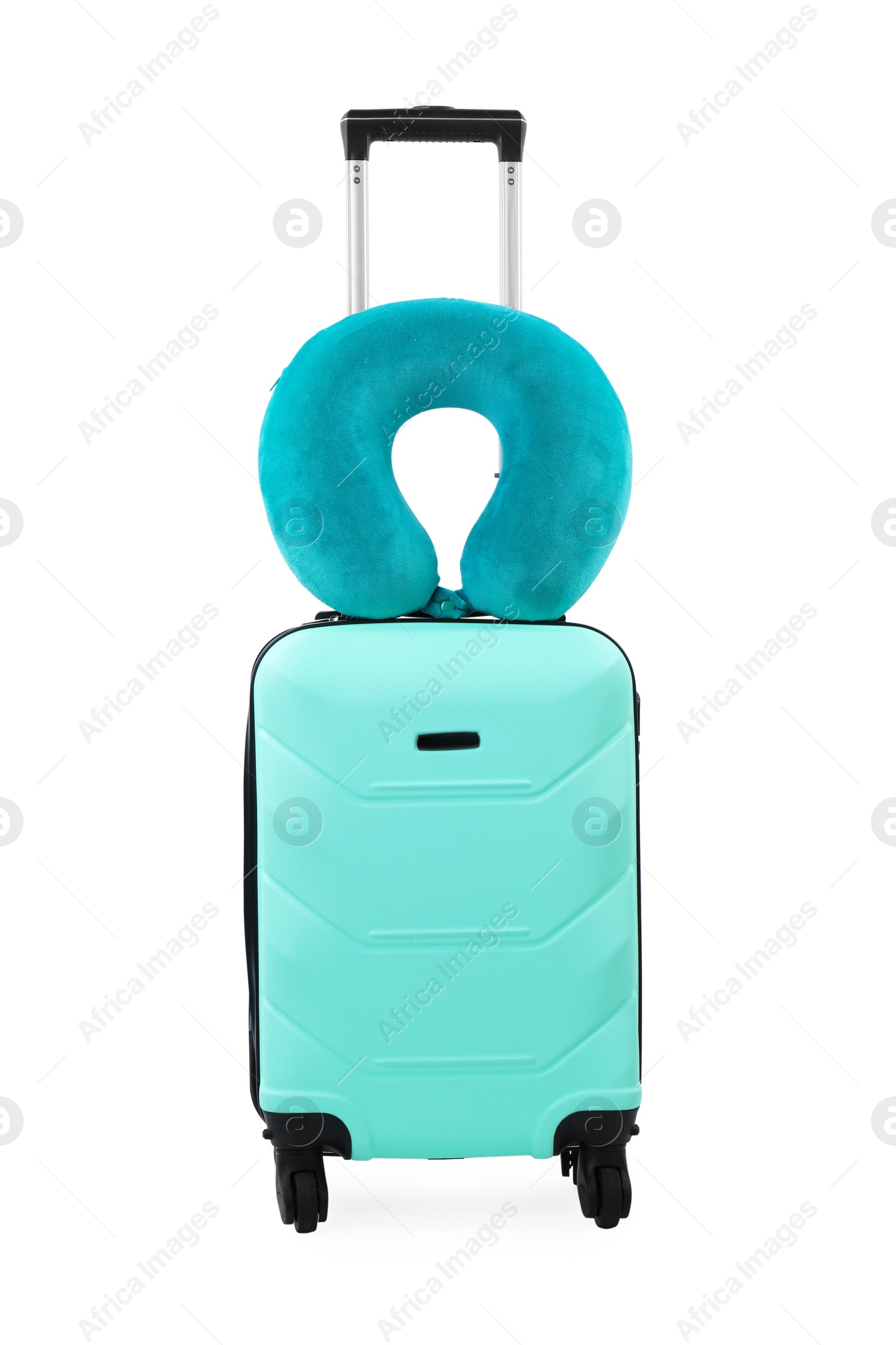 Photo of Soft travel pillow on turquoise suitcase isolated on white