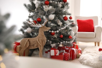 Stylish room interior with Christmas tree and presents