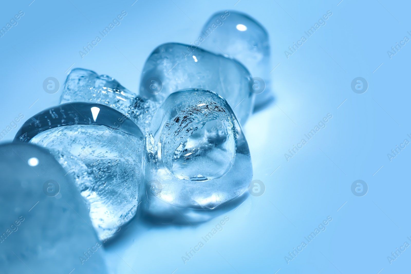 Photo of Ice cubes on color background. Space for text