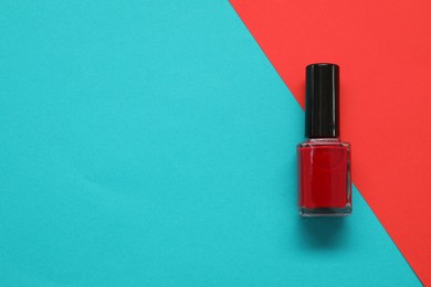 Photo of Nail polish on color background, top view. Space for text