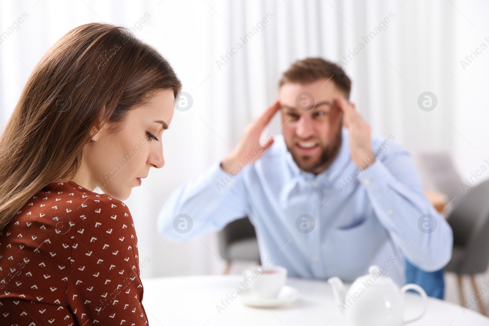 Photo of Couple having quarrel in cafe. Relationship problems