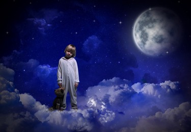 Image of Boy holding toy and sleepwalking on clouds in starry sky with full moon