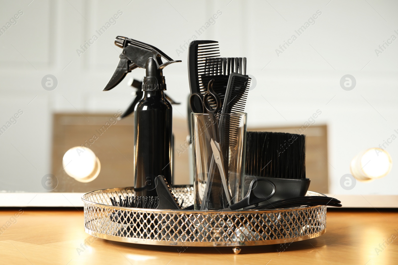 Photo of Set of hairdresser tools on table in salon