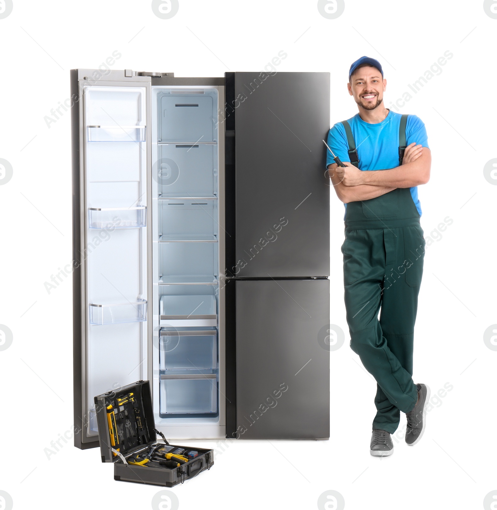 Photo of Male technician with tool box near refrigerator on white background