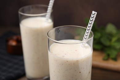 Photo of Glasses of delicious date smoothie on table, closeup
