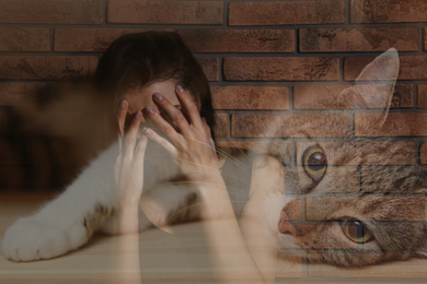 Image of Woman suffering from ailurophobia indoors. Irrational fear of cats