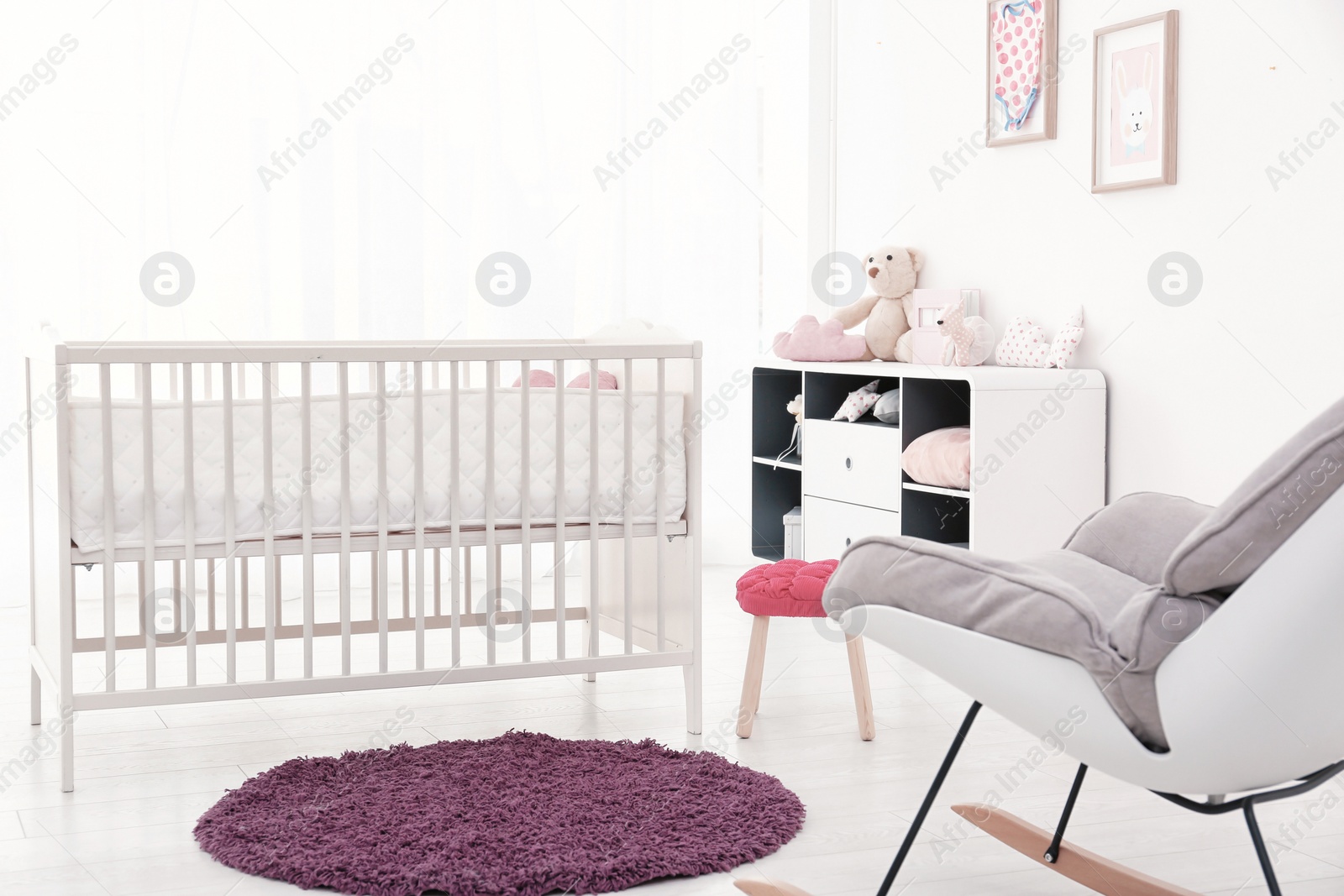 Photo of Baby room interior with comfortable crib and rocking chair