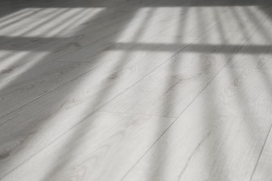 Photo of Shadow from window and curtains on white laminated floor