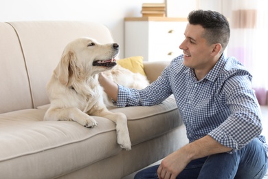 Portrait of owner with his friendly dog at home