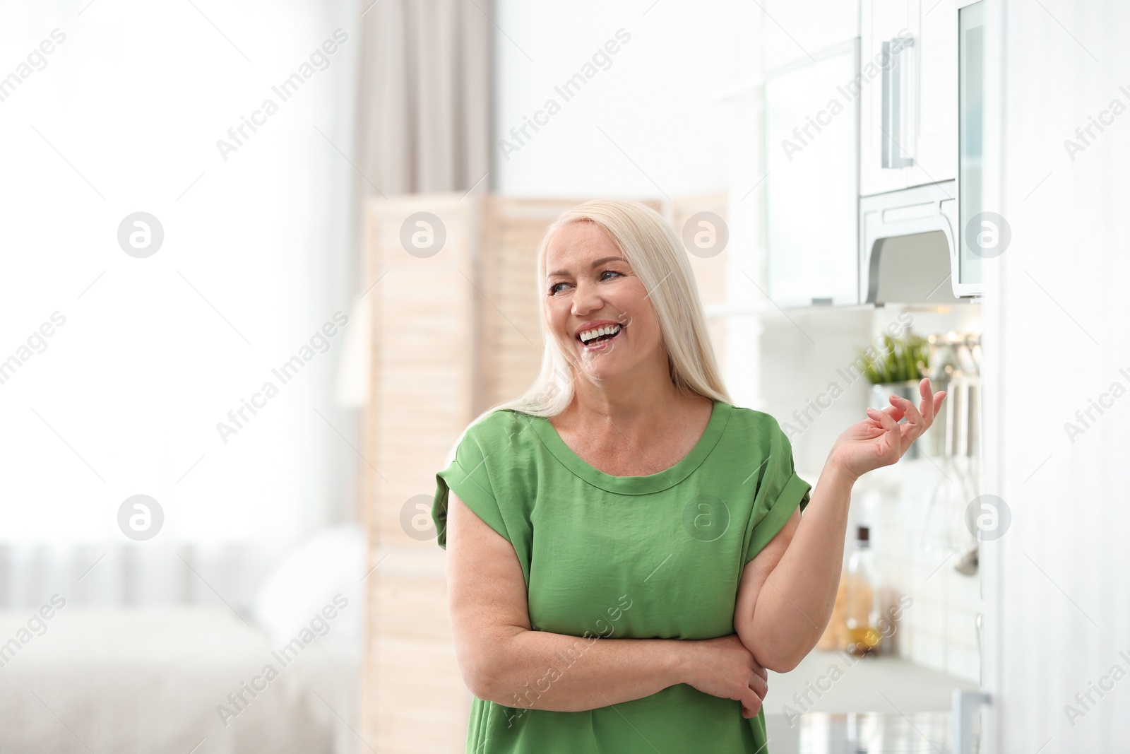 Photo of Portrait of happy mature woman at home