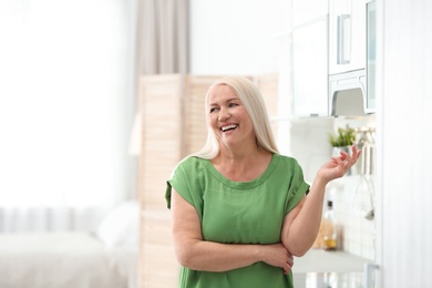 Photo of Portrait of happy mature woman at home