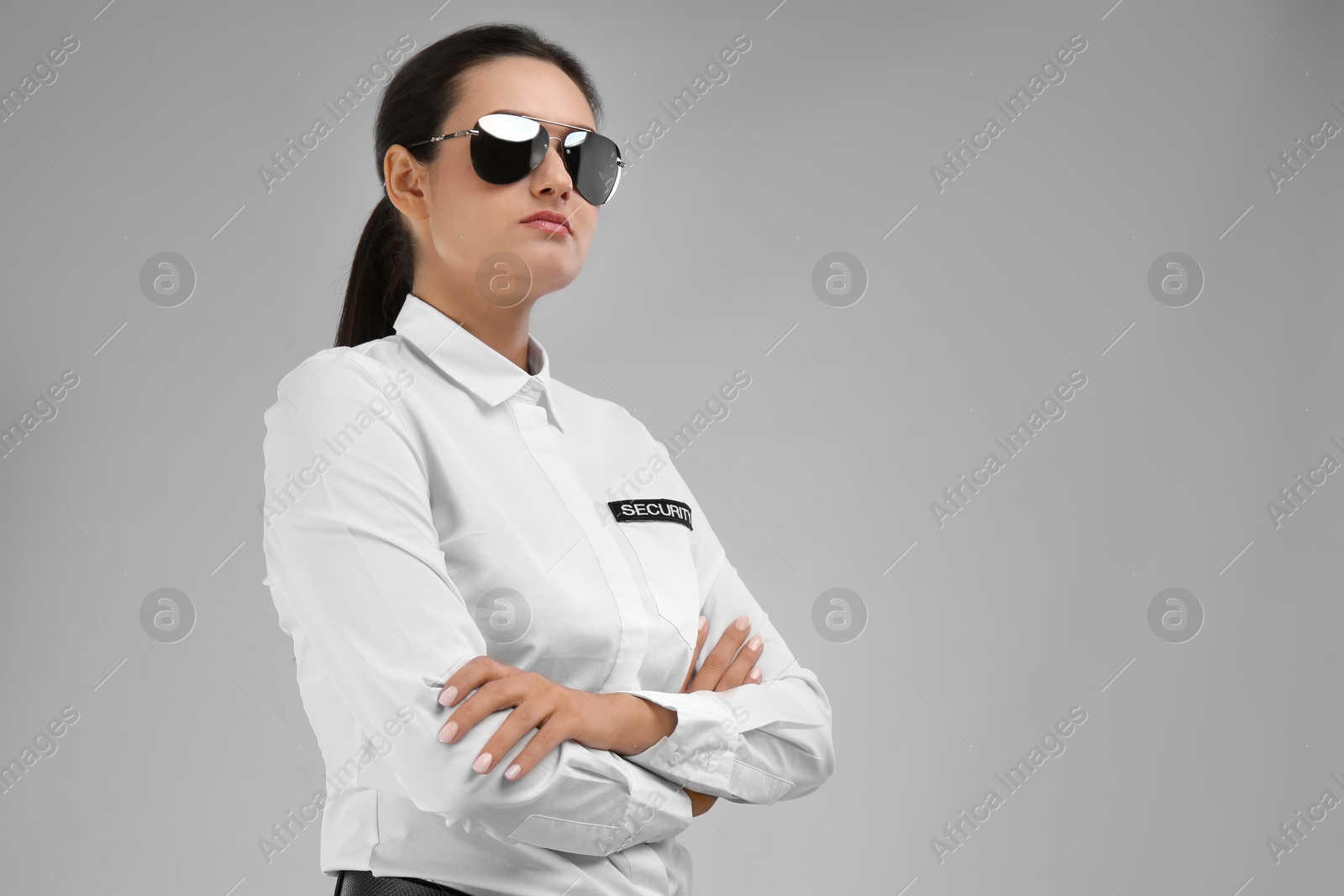 Photo of Female security guard in uniform on color background