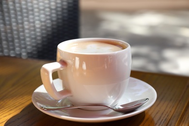 Aromatic coffee on wooden table outdoors, closeup