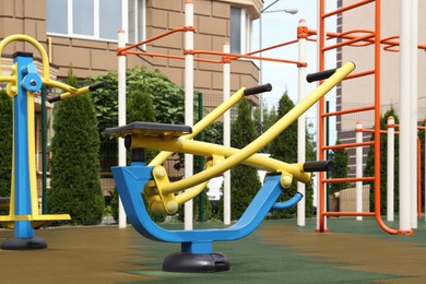 Photo of Empty outdoor playground with exercise equipment in residential area