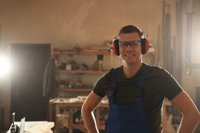 Photo of Portrait of professional male carpenter in workshop