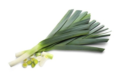 Whole and cut fresh leeks on white background