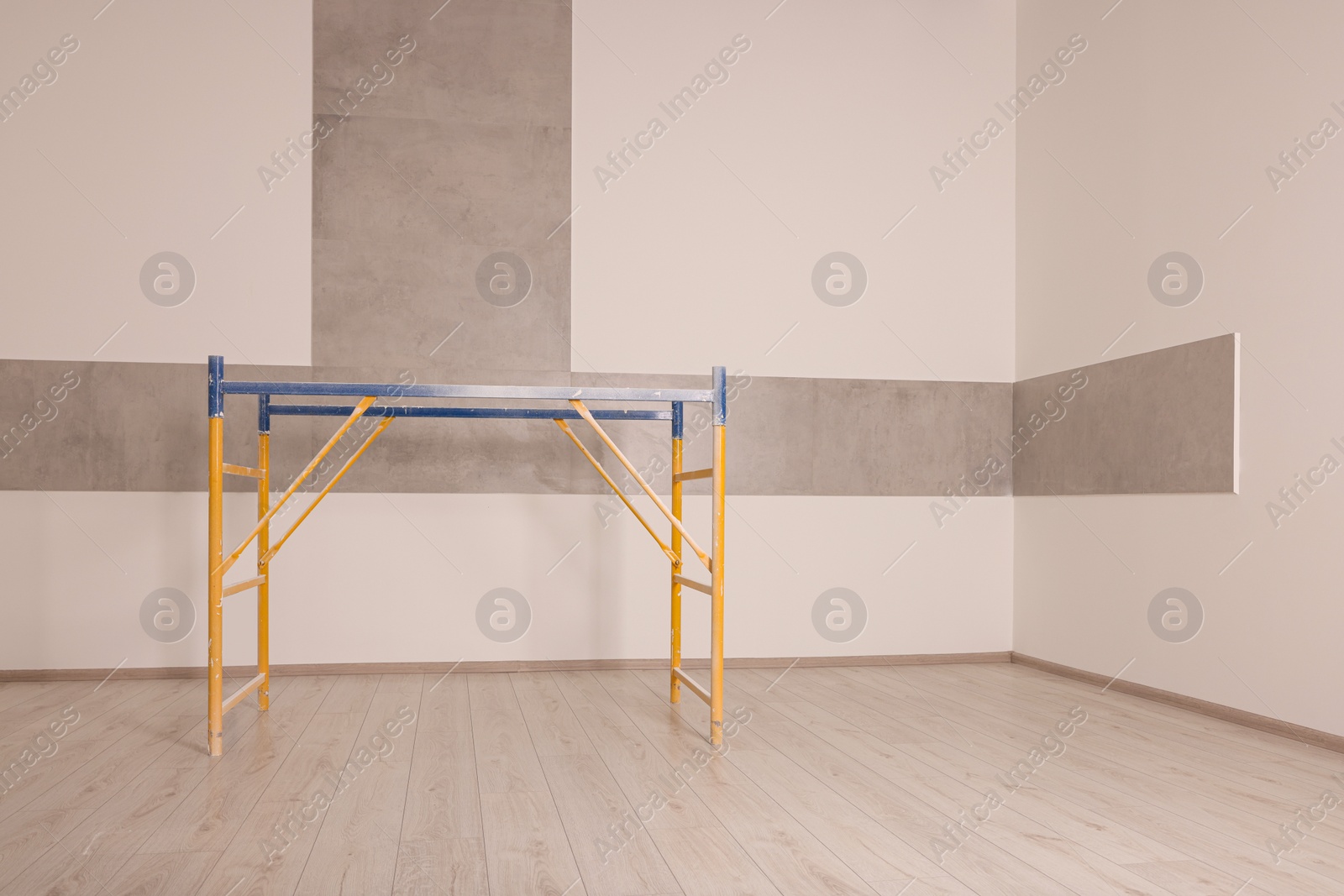 Photo of Professional construction scaffold in empty renovated room