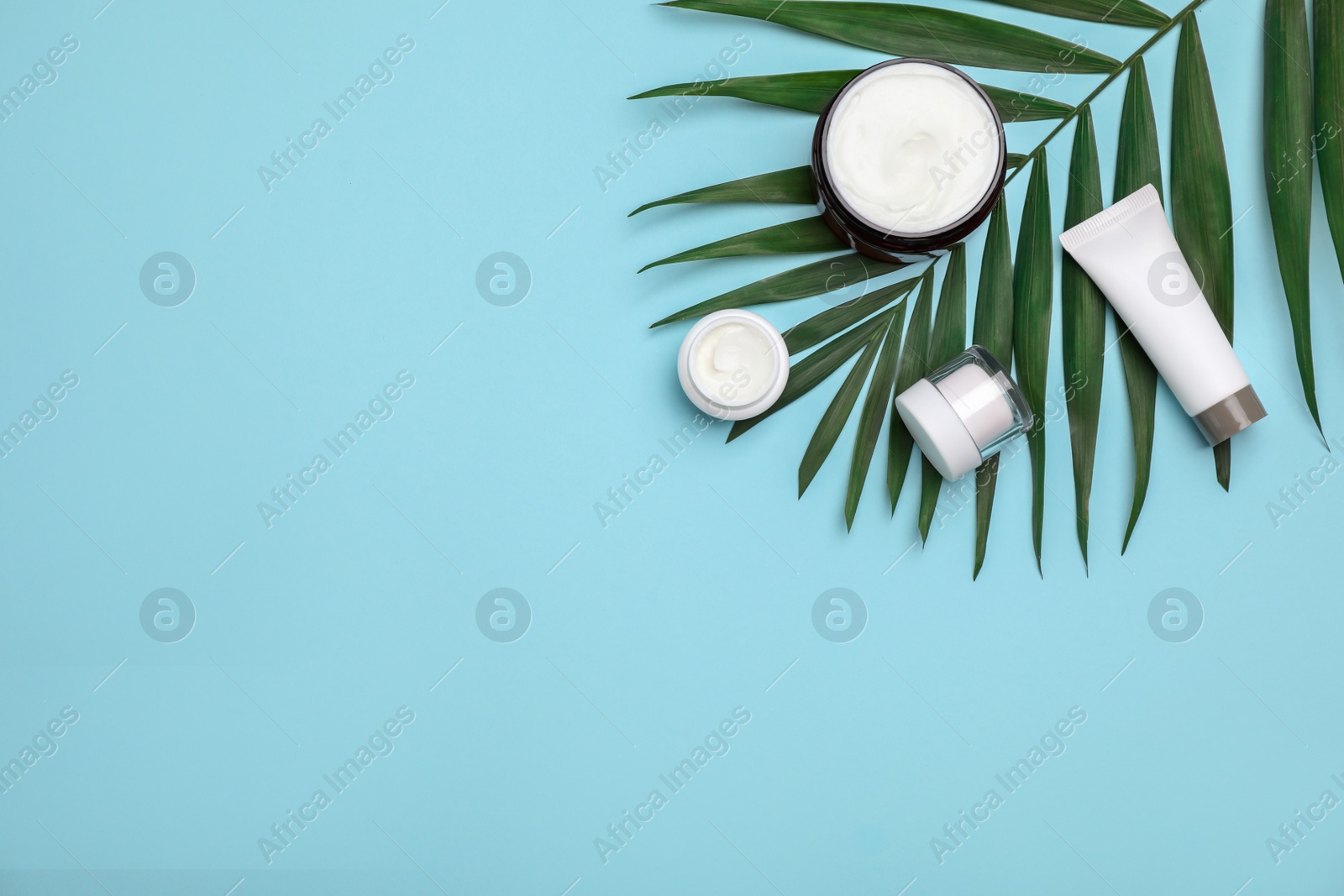 Photo of Flat lay composition with cosmetic products on color background