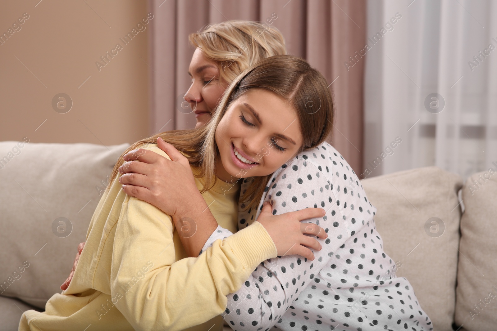 Photo of Young woman with her mom at home. Happy Mother's Day