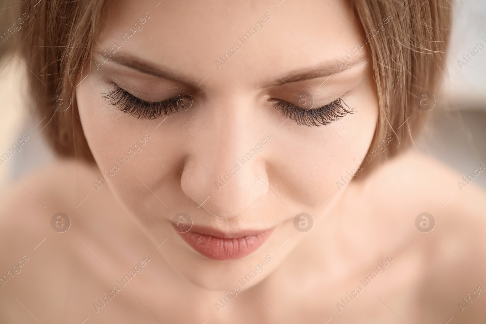 Photo of Attractive young woman with beautiful eyelashes, closeup
