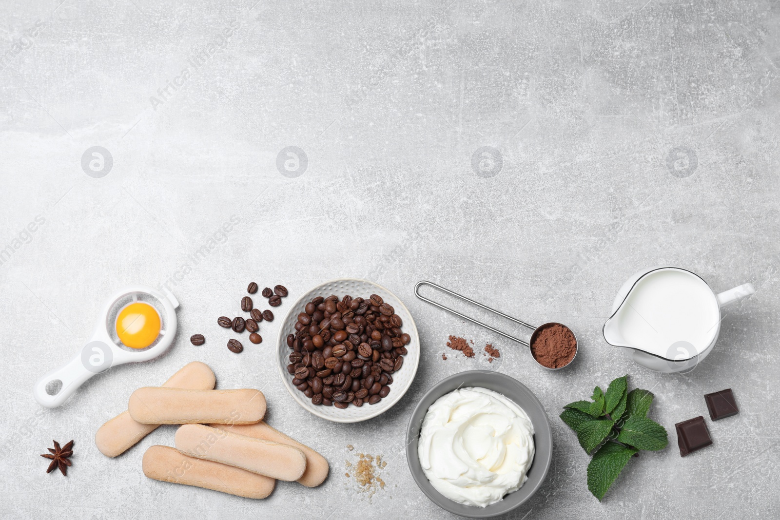 Photo of Flat lay composition with tiramisu ingredients on grey table, space for text