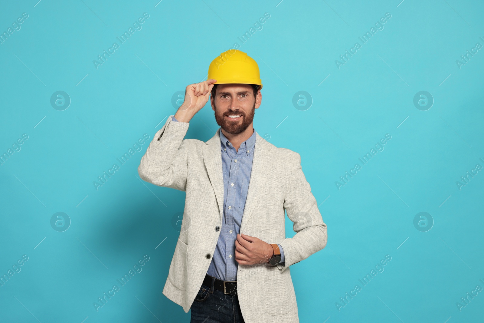 Photo of Professional engineer in hat on light blue background