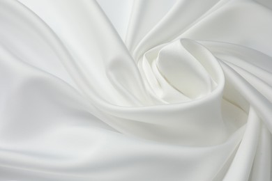 Texture of crumpled white silk fabric as background, closeup