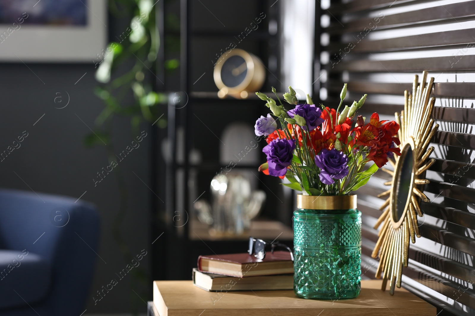 Photo of Glass vase with fresh flowers on wooden table. Space for text