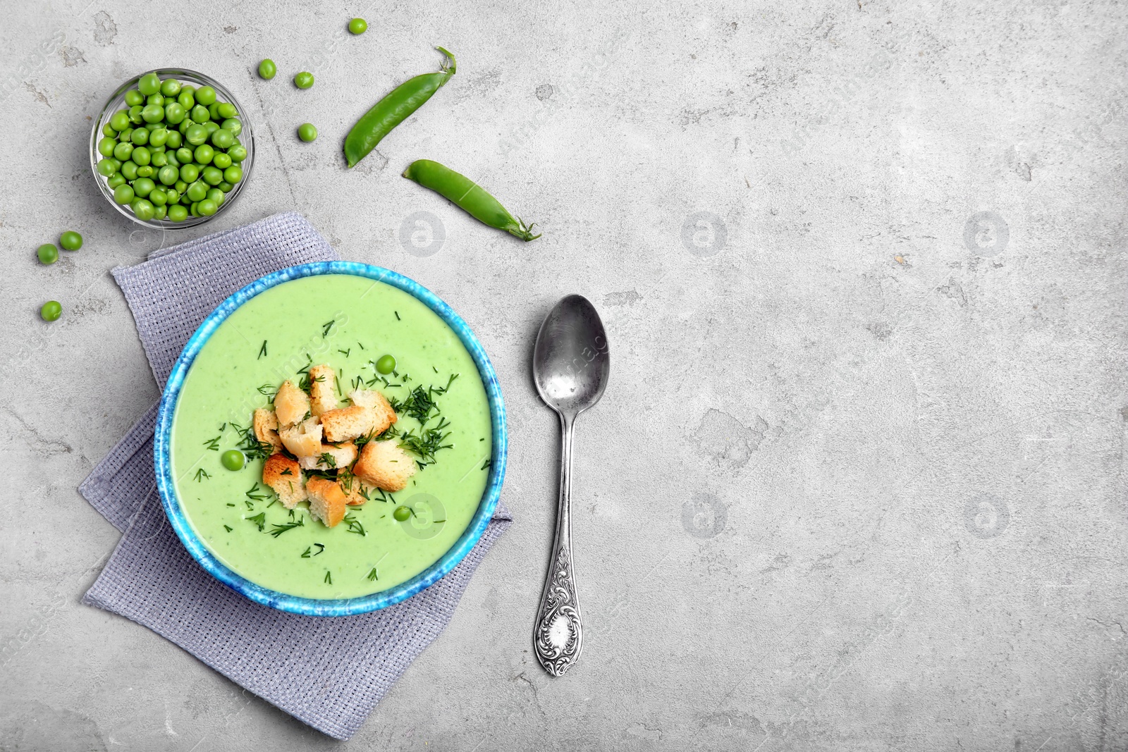 Photo of Flat lay composition with green pea soup on grey background