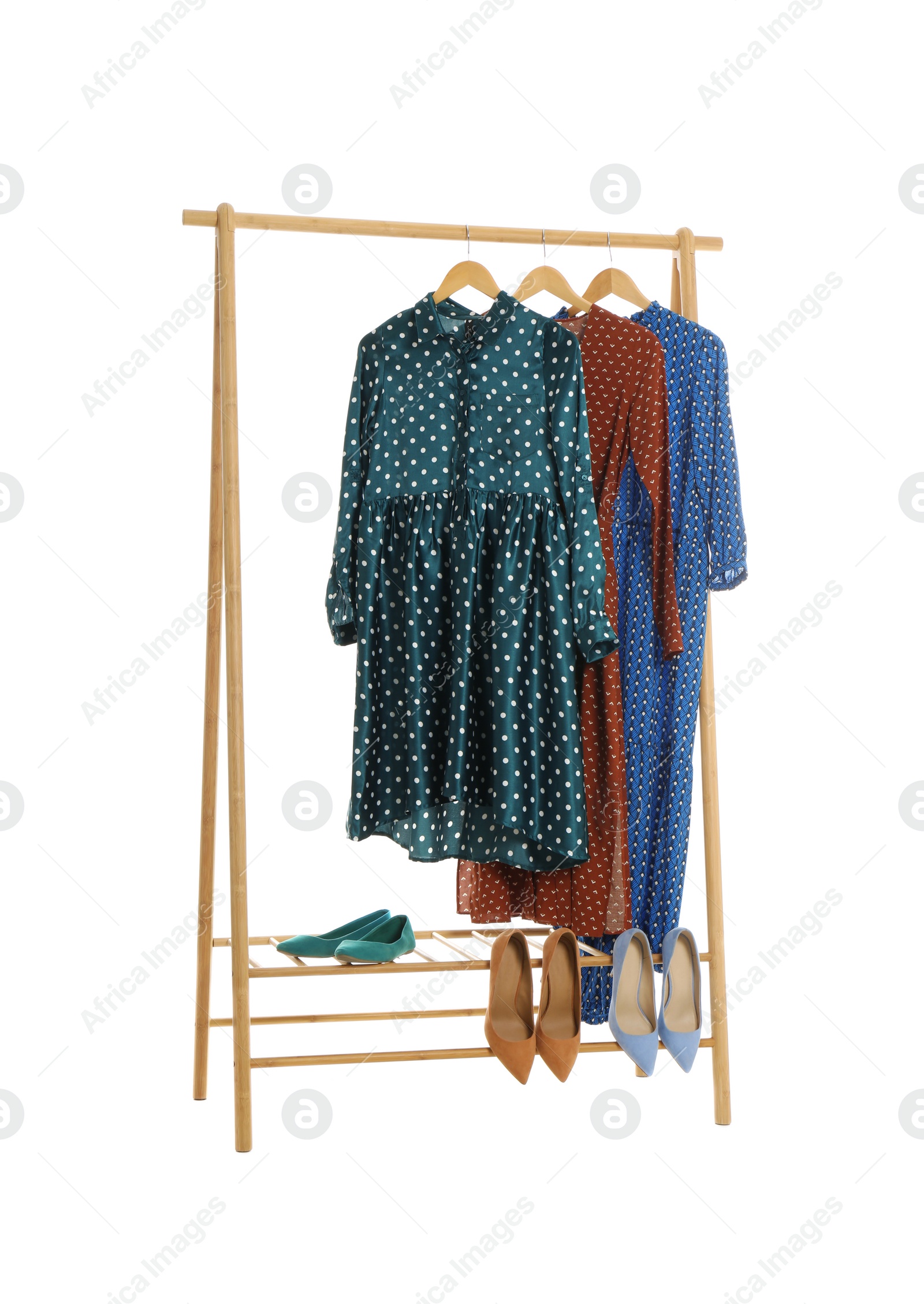 Photo of New wardrobe rack with stylish lady's clothes and shoes on white background