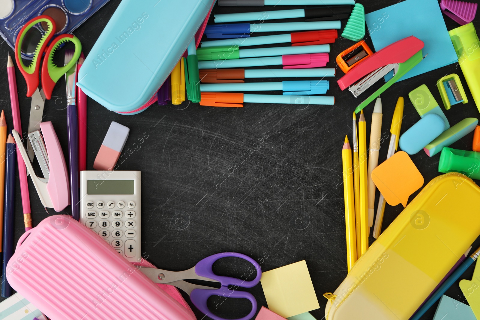 Photo of Frame of different stationery on blackboard, flat lay with space for text. Back to school