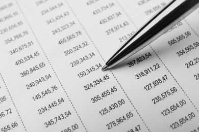 Photo of Accounting document with data and pen, closeup