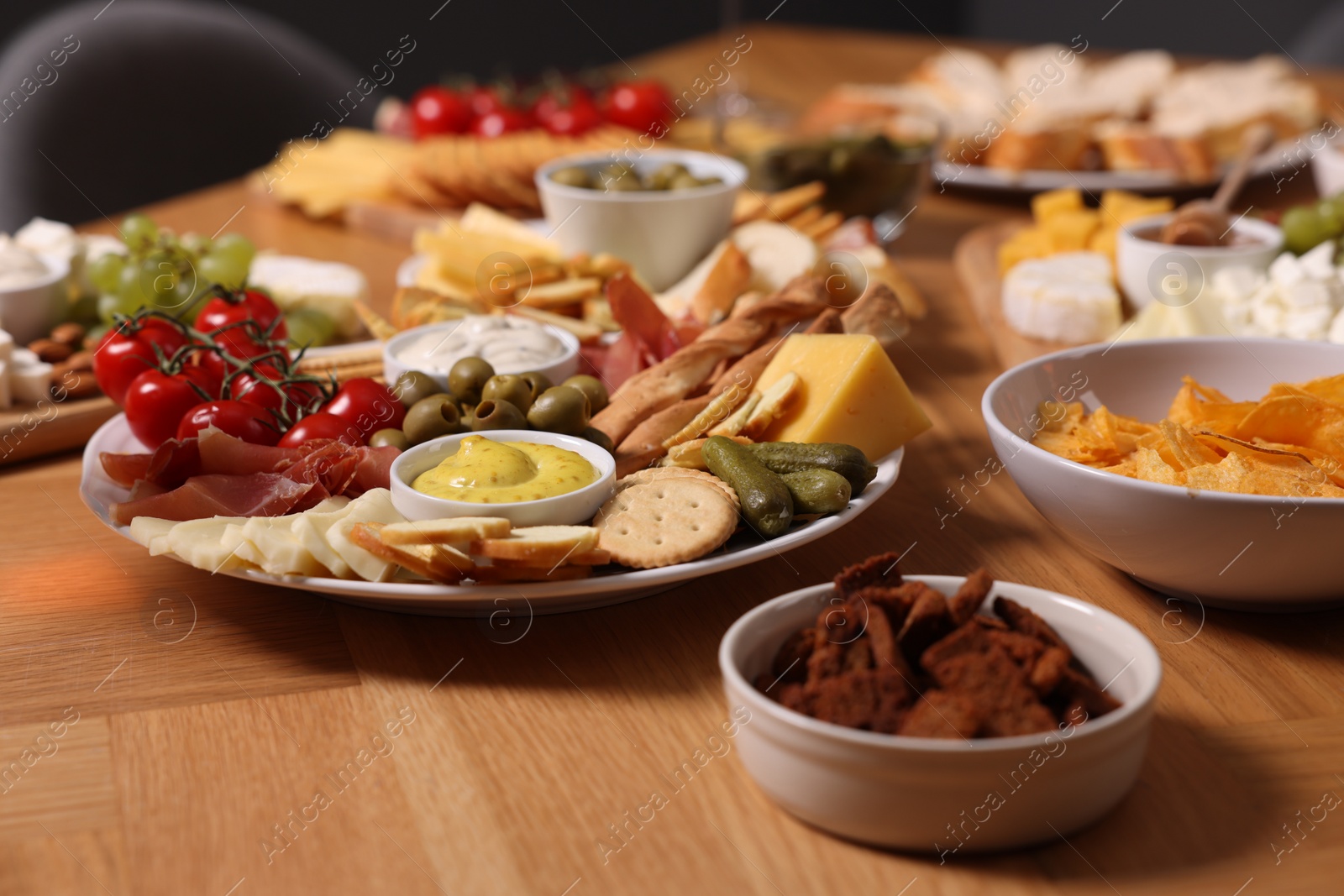 Photo of Assorted appetizers served on wooden table, closeup